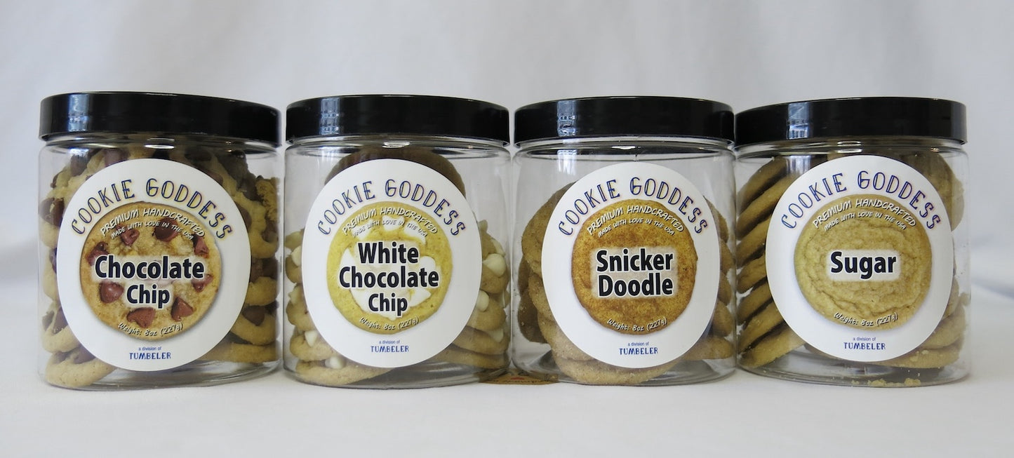 Four jars of Cookie Goddess cookies with different flavors on labels.