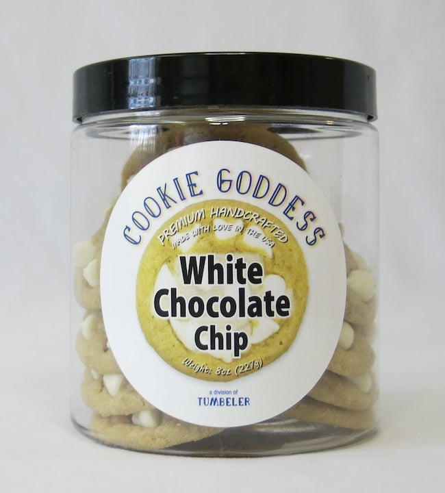 Jar of 'Cookie Goddess' white chocolate chip cookies with a black lid on a white background